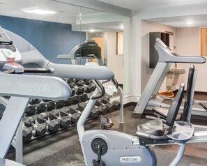A gym with various exercise equipment including treadmills, a stationary bike, and dumbbells. - Comfort Inn Williamsburg Gateway (Williamsburg)