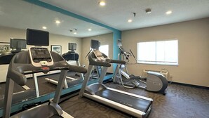 A gym with treadmills, exercise bikes, and a mirrored wall. - Country Inn & Suites by Radisson, Bismarck-Mandan (Bismarck)
