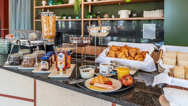 A breakfast buffet with various food items, including pastries, bread, and condiments. - B&B Hotel Rothrist Olten (Rothrist)