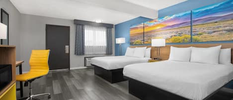 A hotel room with two beds, a desk, a chair, a TV, and a large landscape painting on the wall.