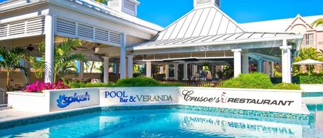 A pool area with a sign for 'Pool Bar & Veranda' and 'Cruise's Restaurant'.