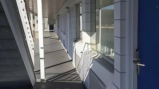 A corridor with a ramp leading to a room with a window. - Capitol Inn by Belvilla Richmond Airport VA (Sandston)
