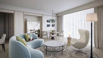 Una sala de estar moderna con un sofá, un sillón, una mesita redonda y una lámpara.