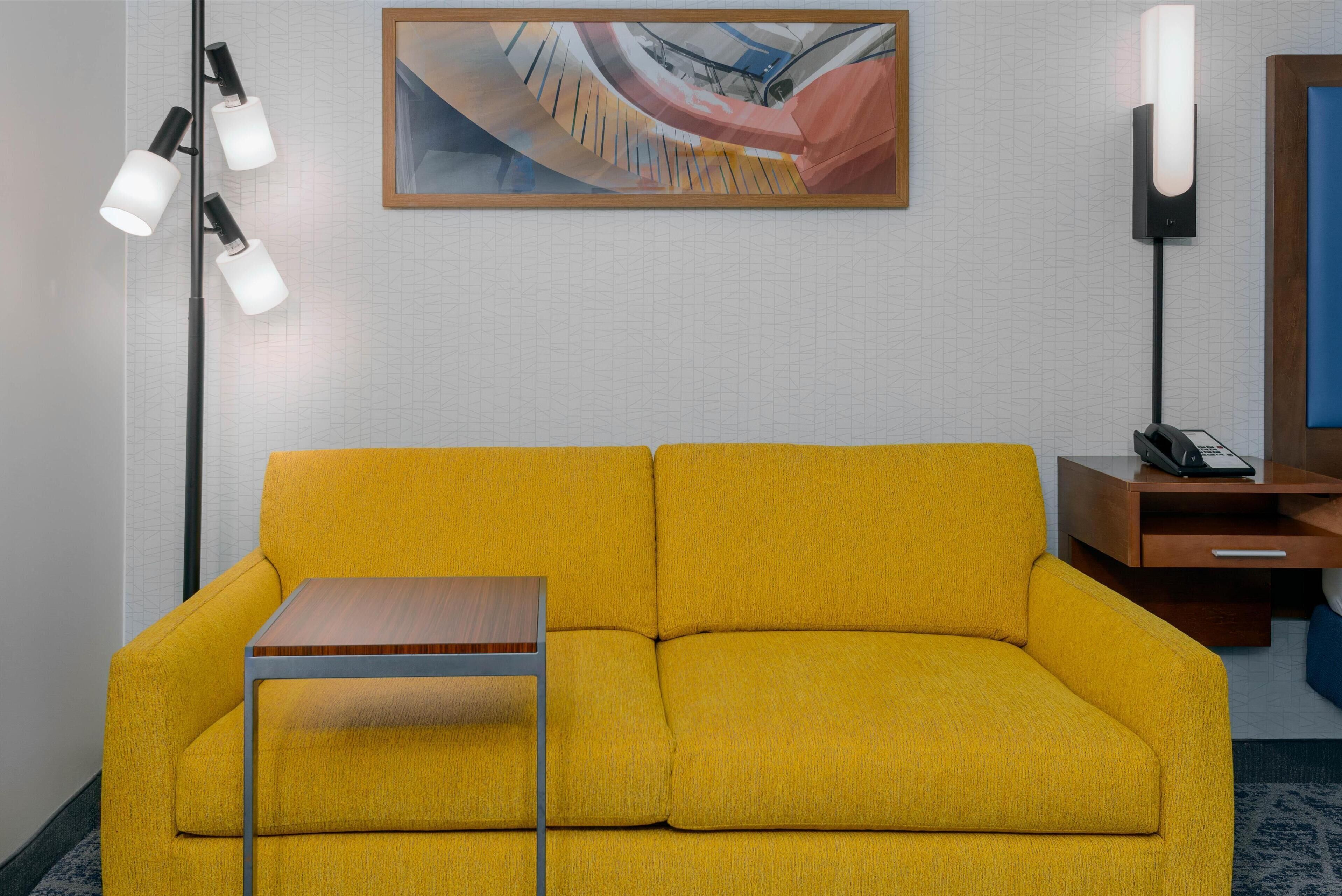 deluxe, one king bed, pullout couch, non-smoking | living area | 50-inch flat-screen tv with cable channels, tv