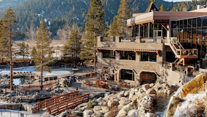 A lodge with a stone facade, outdoor seating, and a pool area. - Everline Resort and Spa, Lake Tahoe (Olympic Valley)