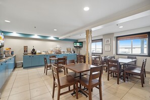 A restaurant with a bar area, dining tables, and chairs.