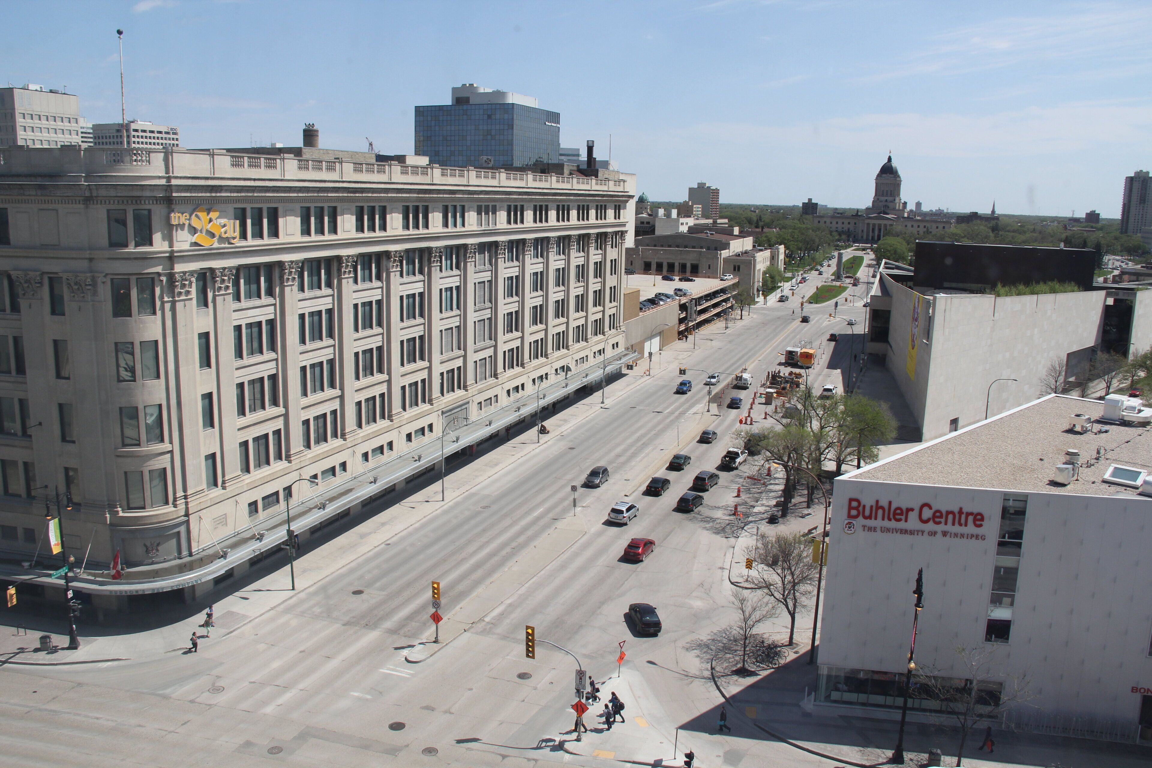 A multi-story building with a flat facade, a large sign on the side, and a clear sky.