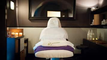 Experience a serene retreat with a treatment bed, mirror, and thoughtful amenities.