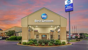 A Best Western hotel with a beige facade, a prominent 'BW' logo, and a sign stating 'Best Western'.