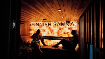 A sauna with wooden benches and a sign that reads "FINNISH SAUNA".
