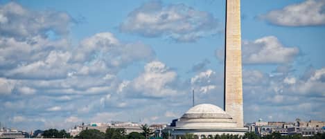 A tall monument with a dome and a bridge in the foreground.