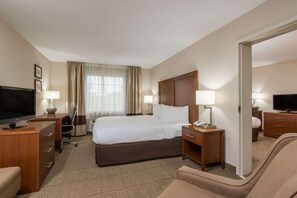 Relax in comfort with a large bed, flat-screen TV, and convenient workspace.