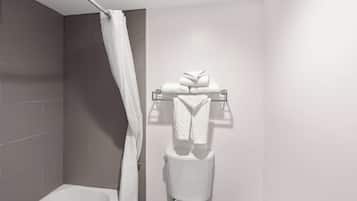 A bathroom with a bathtub, a toilet, and a towel rack with folded towels.