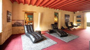 A room with two leather recliners, a red ceiling, and a red carpet.