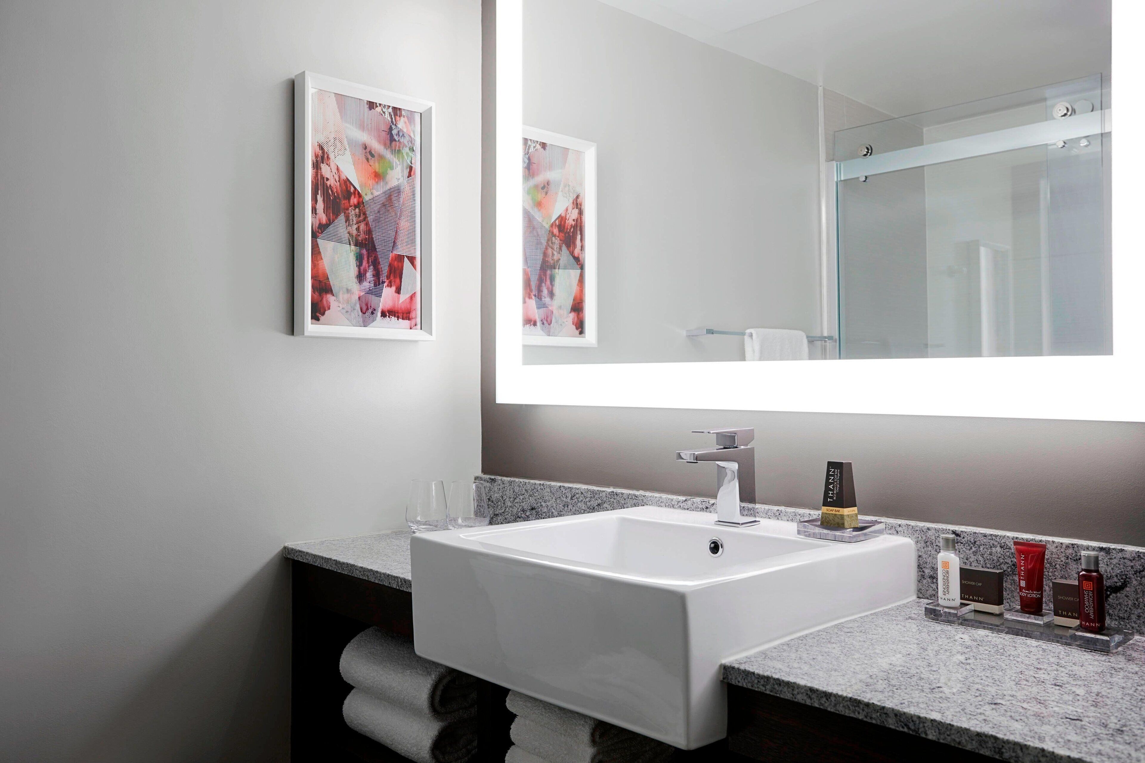 combined shower/bathtub, designer toiletries, hair dryer, towels