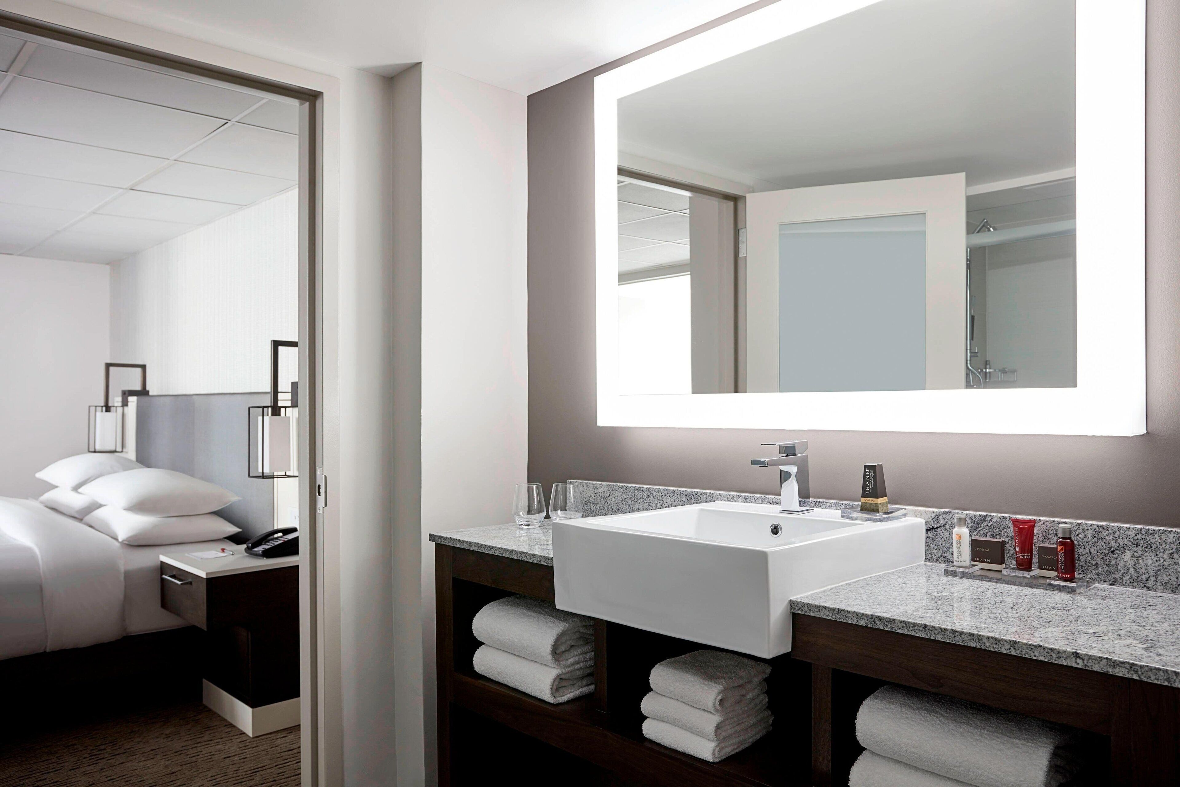 combined shower/bathtub, designer toiletries, hair dryer, towels