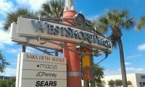 A sign for Westside Plaza with store names Macy's, JC Penney, and Sears.
