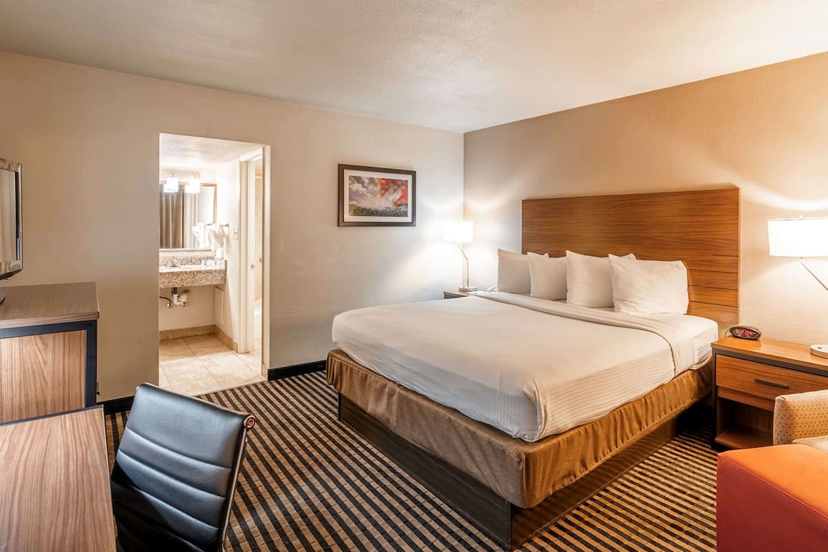 Premium bedding, desk, laptop workspace, iron/ironing board