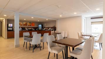 A modern dining area with a counter and seating.