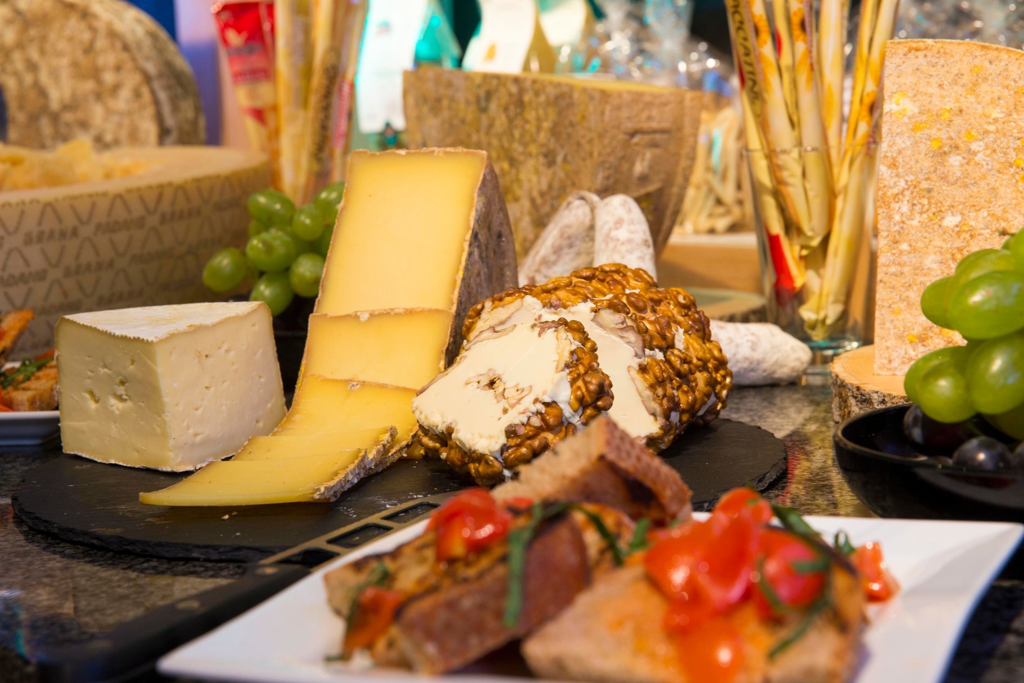 A variety of cheeses and bread on a table.