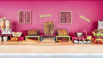 A bakery counter with various baked goods and jars of preserves.