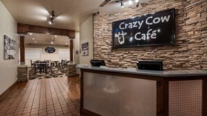 A reception area with a stone wall and a sign reading "Crazy Cow Café". - Best Western Paradise Inn (Beaver)