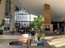 A spacious lobby with a seating area, a bar, and a fireplace.