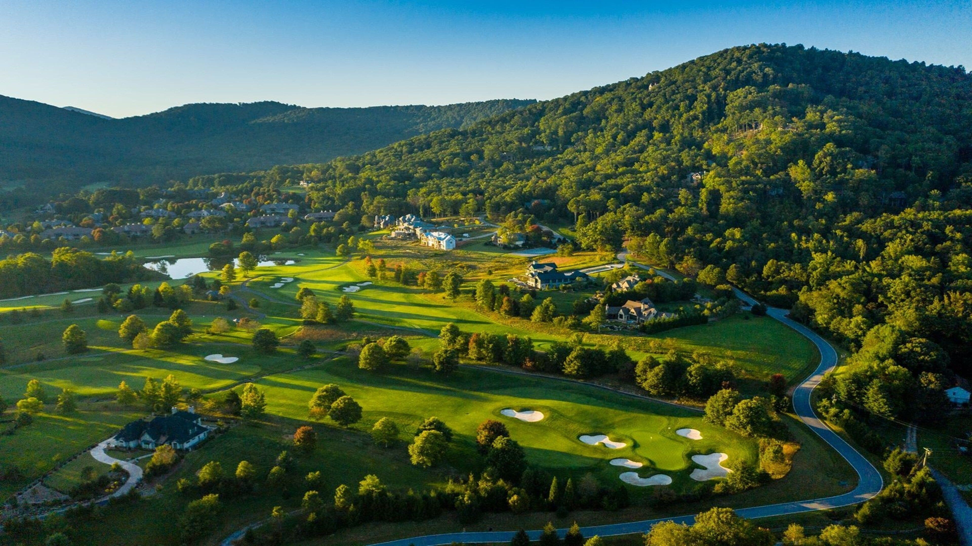 A golf course with multiple holes, a clubhouse, and surrounding residential areas.