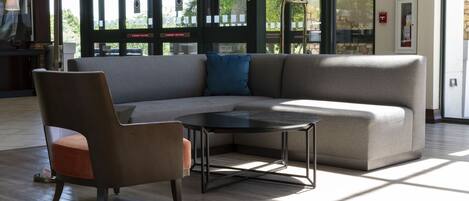 A modern interior with a sofa, chair, and coffee table.