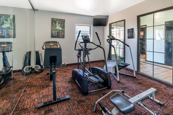 A gym with treadmills, an elliptical, and a stationary bike.