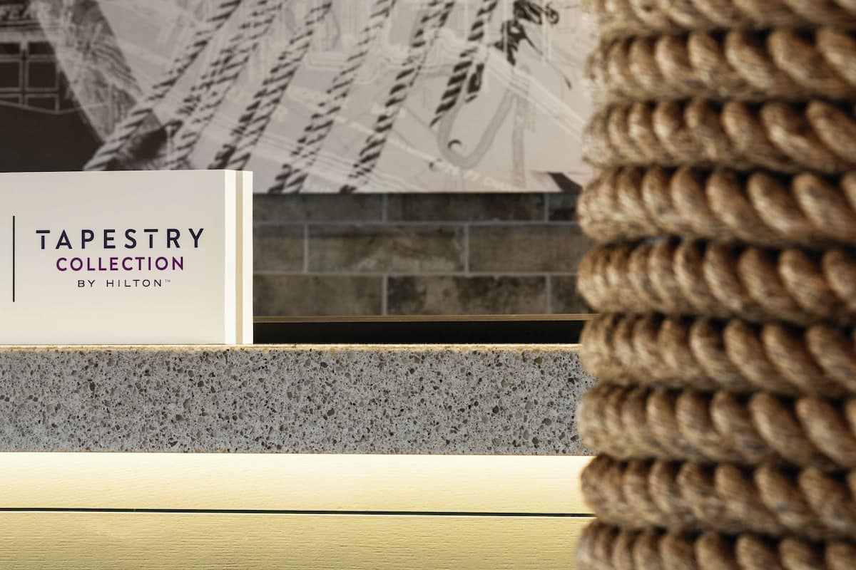 A sign for the Tapestry Collection by Hilton.
