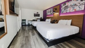 A hotel room with two beds, a desk with a chair, and artwork on the walls. - La Quinta Inn by Wyndham Amarillo Mid-City (Amarillo)