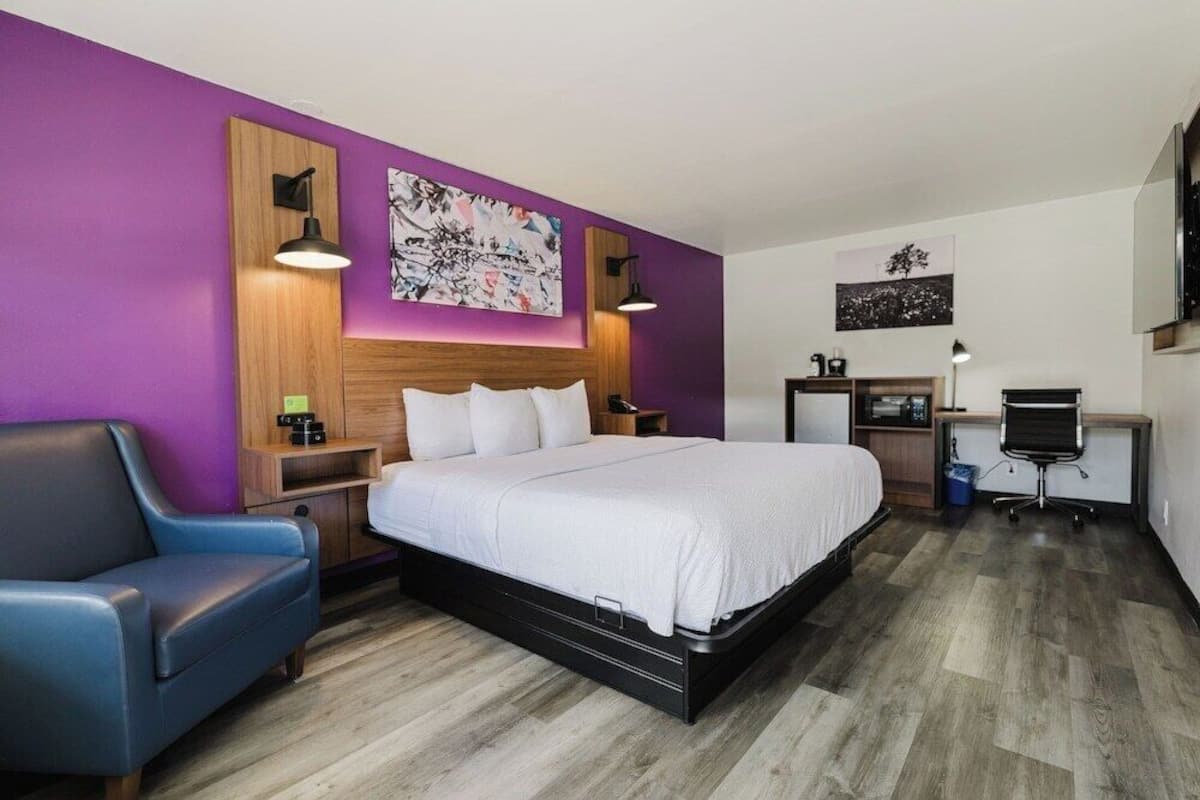 Premium bedding, desk, laptop workspace, blackout drapes