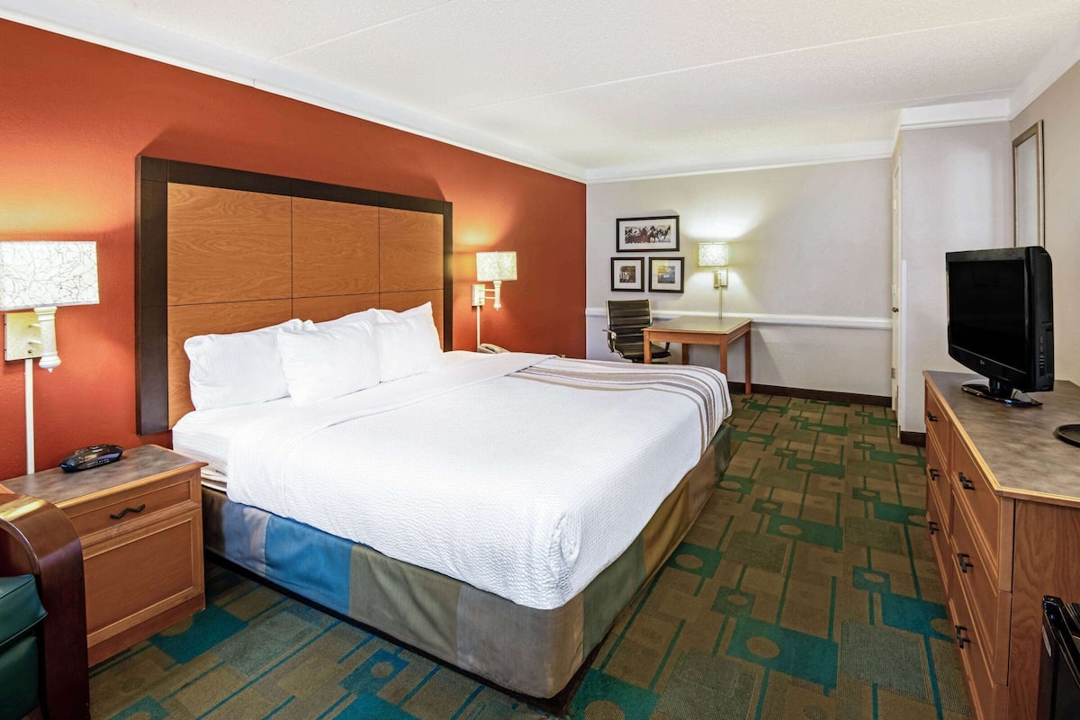 Premium bedding, desk, laptop workspace, blackout curtains