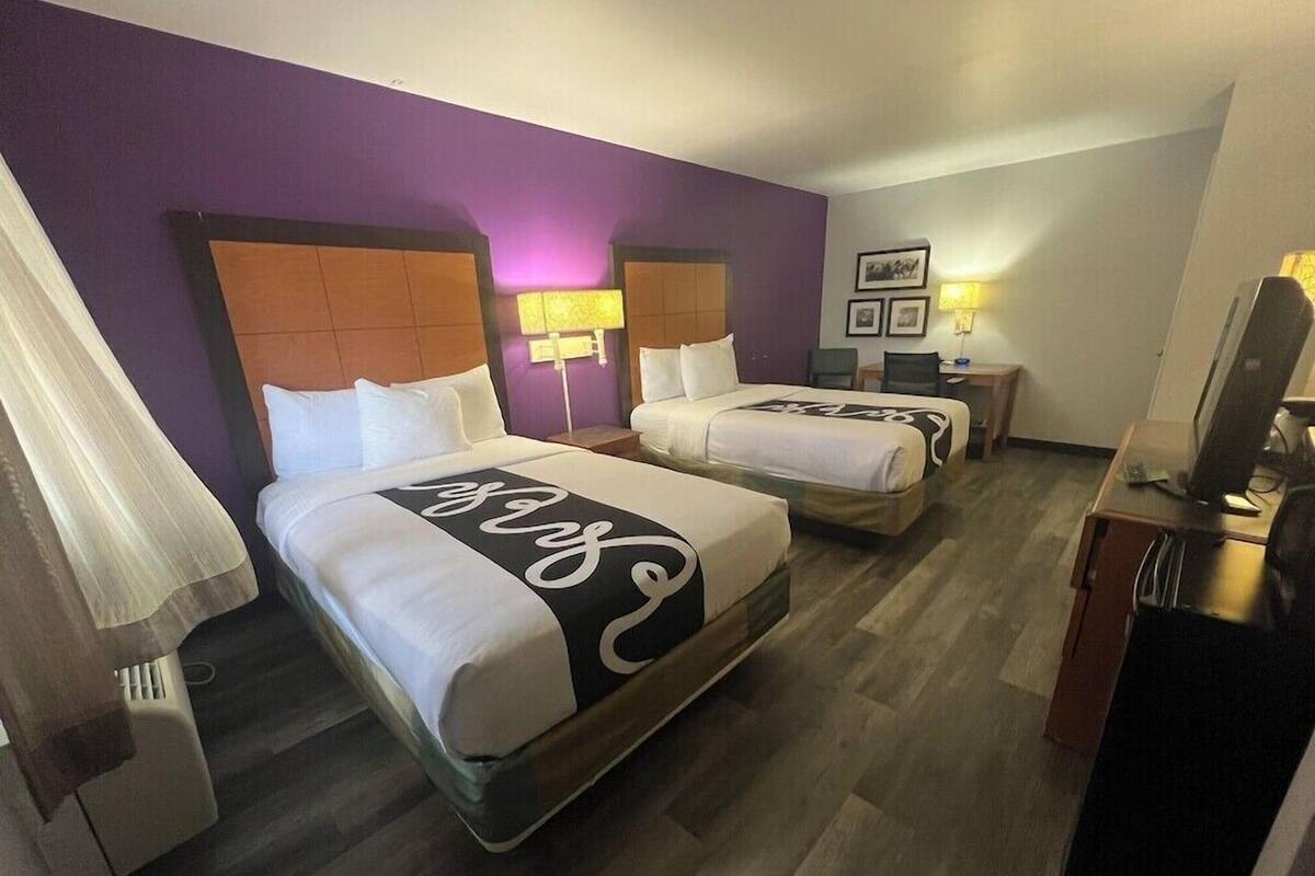 Premium bedding, desk, laptop workspace, blackout drapes