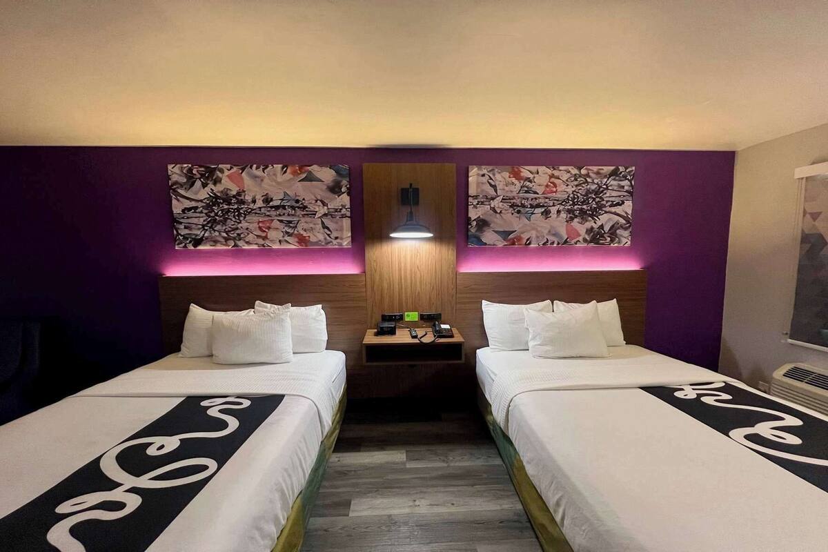 Premium bedding, desk, laptop workspace, blackout drapes