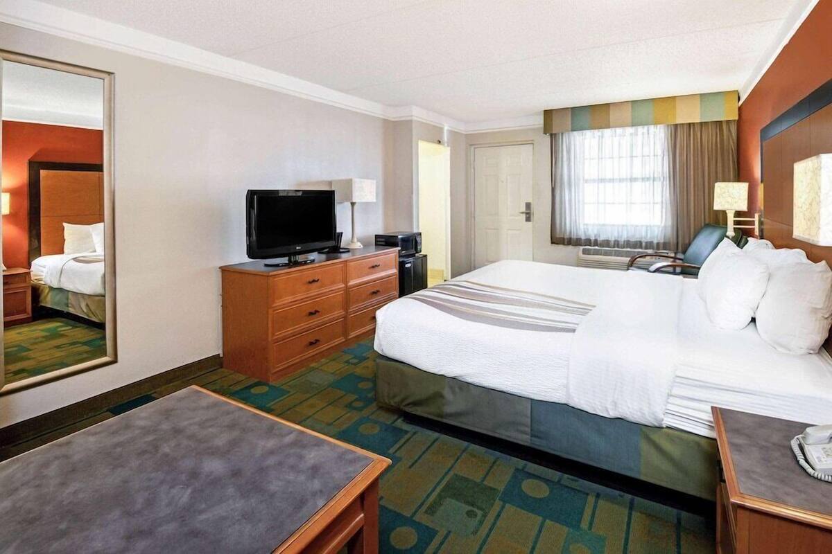Premium bedding, desk, laptop workspace, blackout drapes