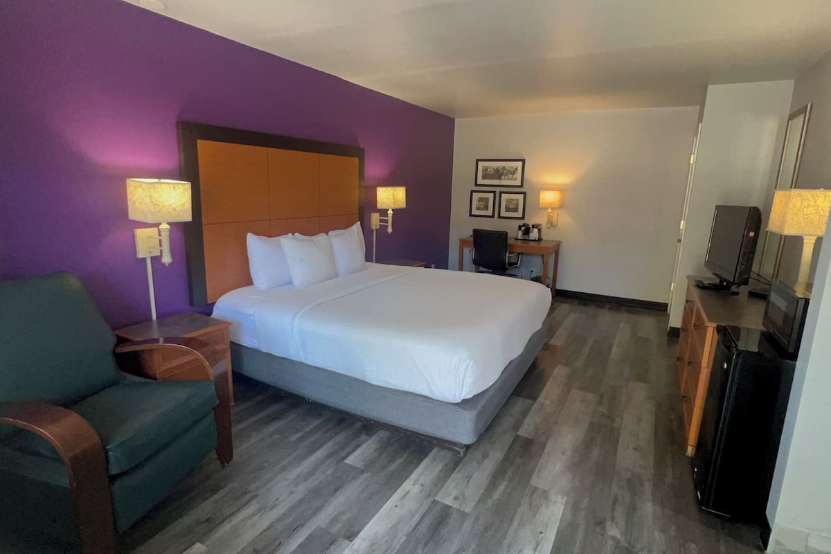 Premium bedding, desk, laptop workspace, blackout drapes