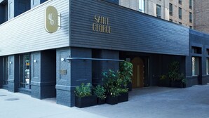 A modern building with a sign reading "SAINT GEORGE" and a logo with a 'S' and 'G'. - Kimpton Saint George by IHG (Toronto)