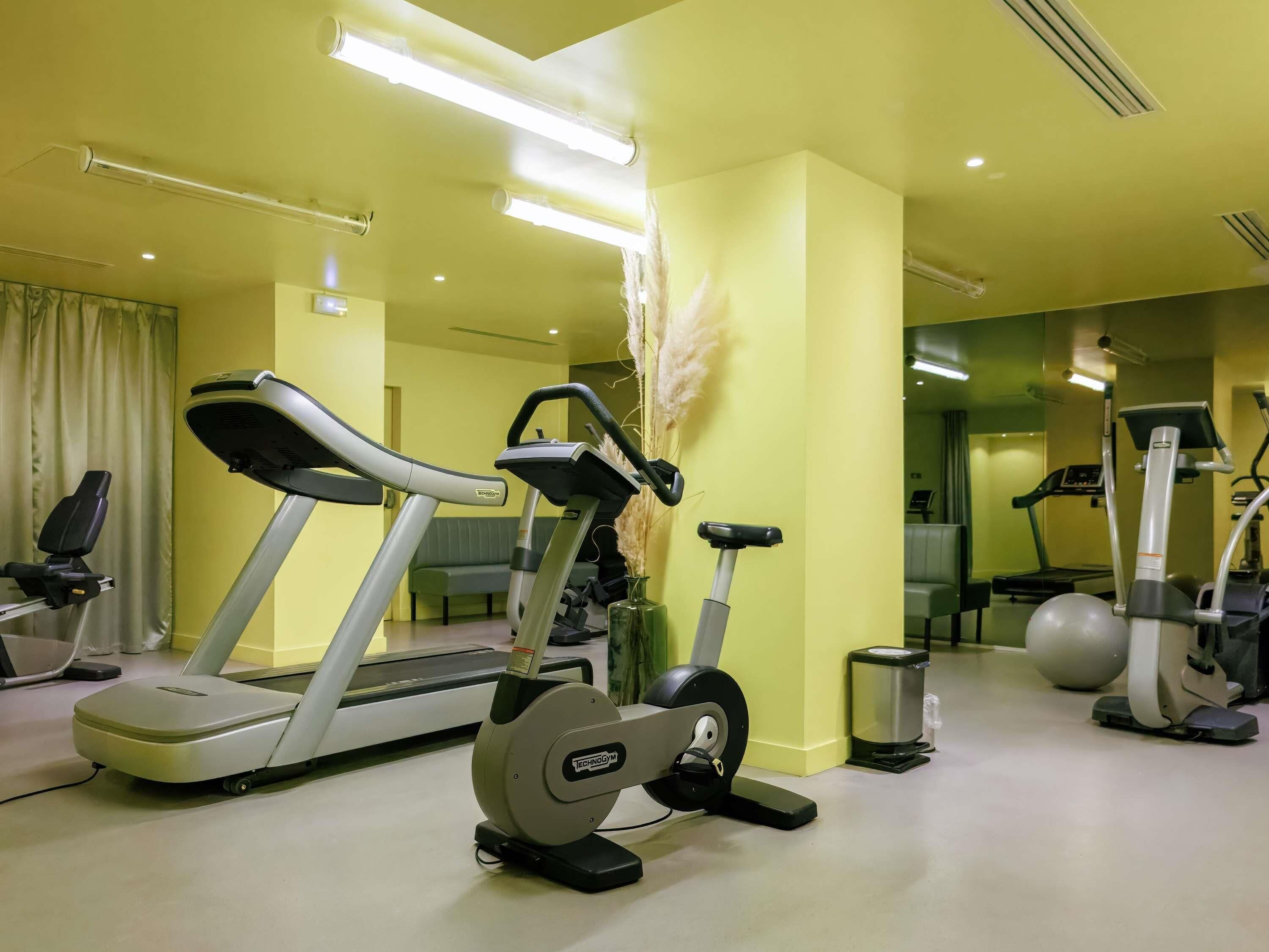 A gym with treadmills, an elliptical, and a stationary bike.