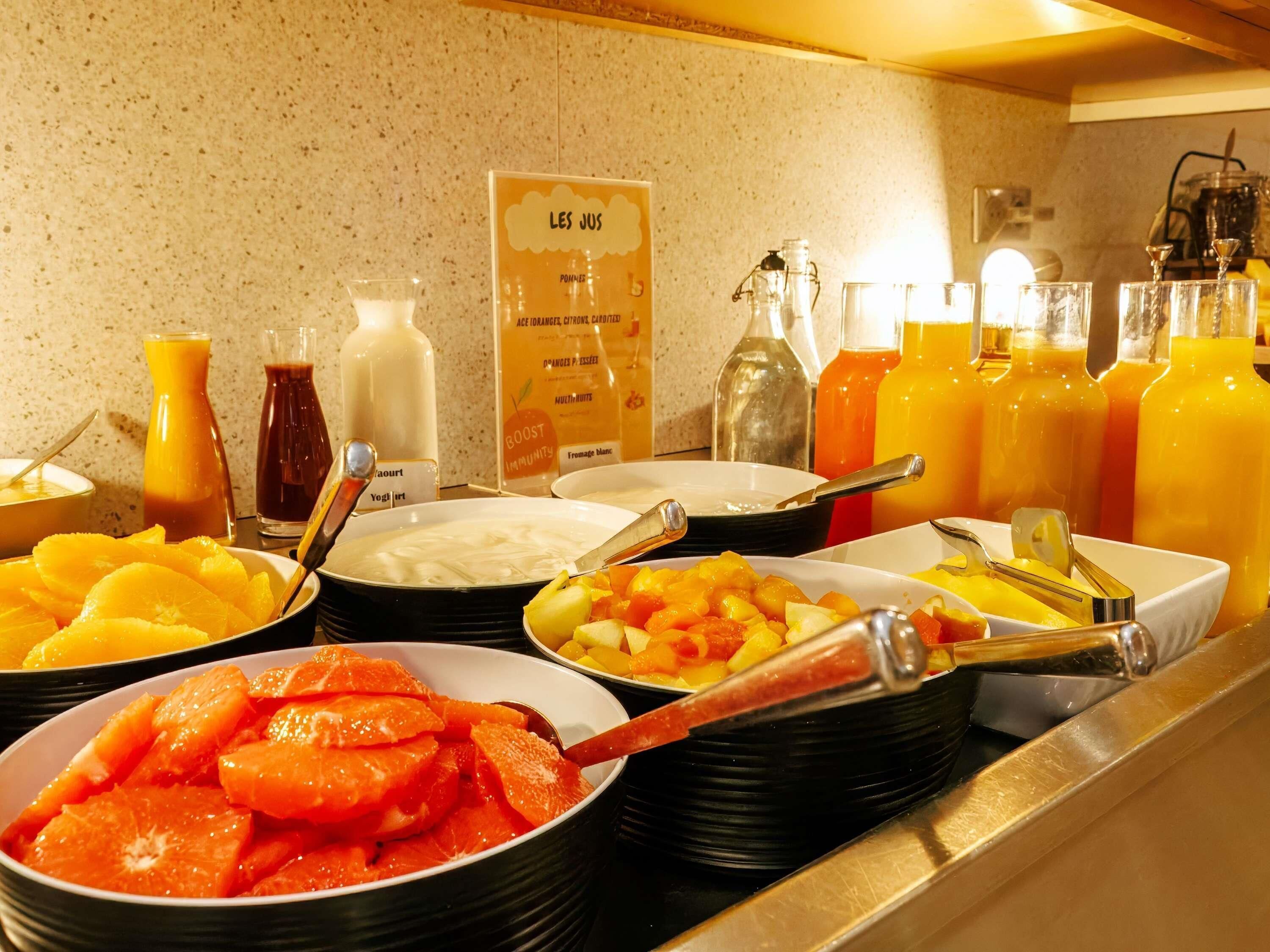 A buffet with various food items and beverages.