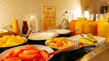 A buffet with various food items and beverages.