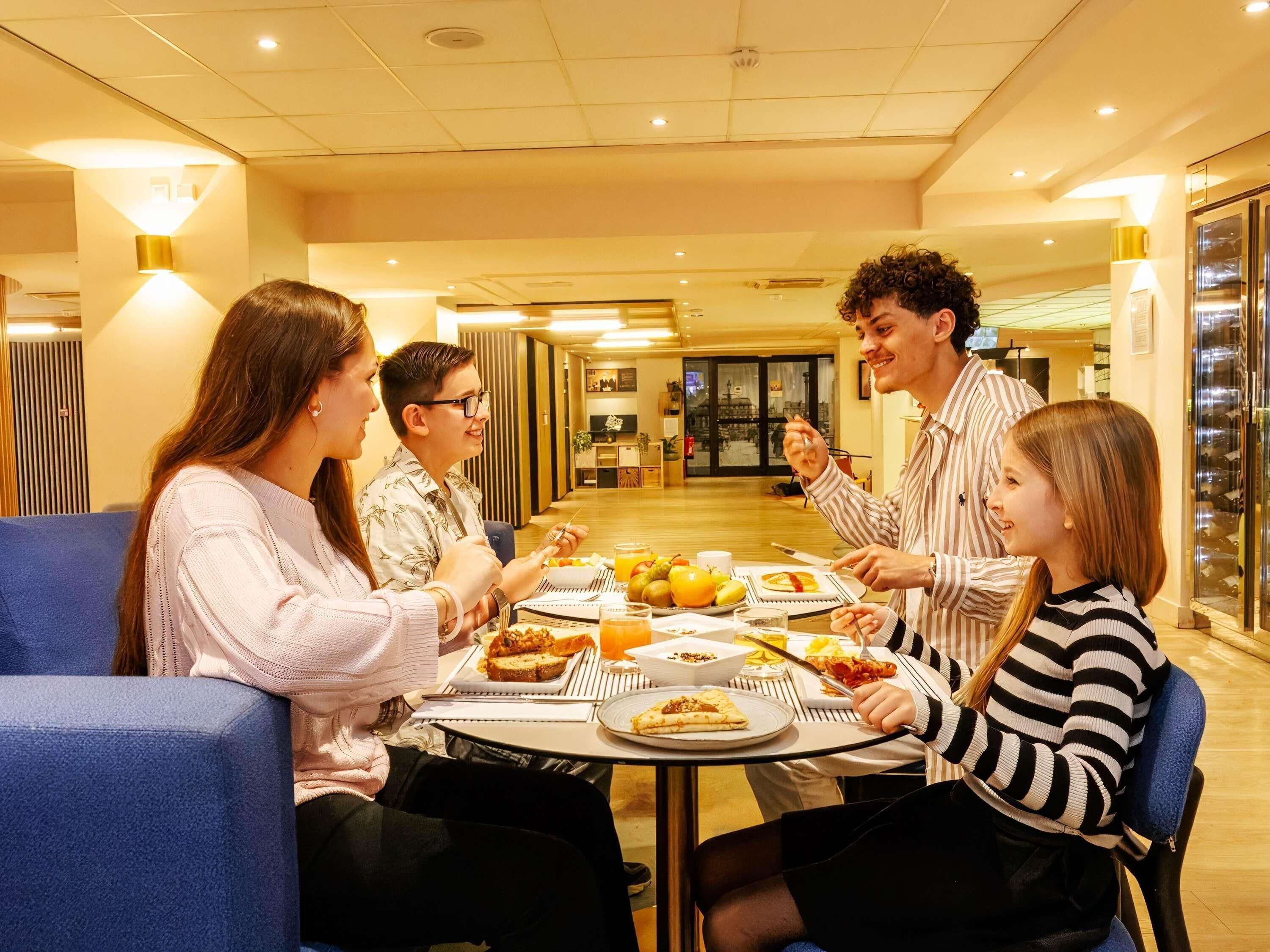 Un espace repas comprenant une table ronde, des chaises et une variété de plats.