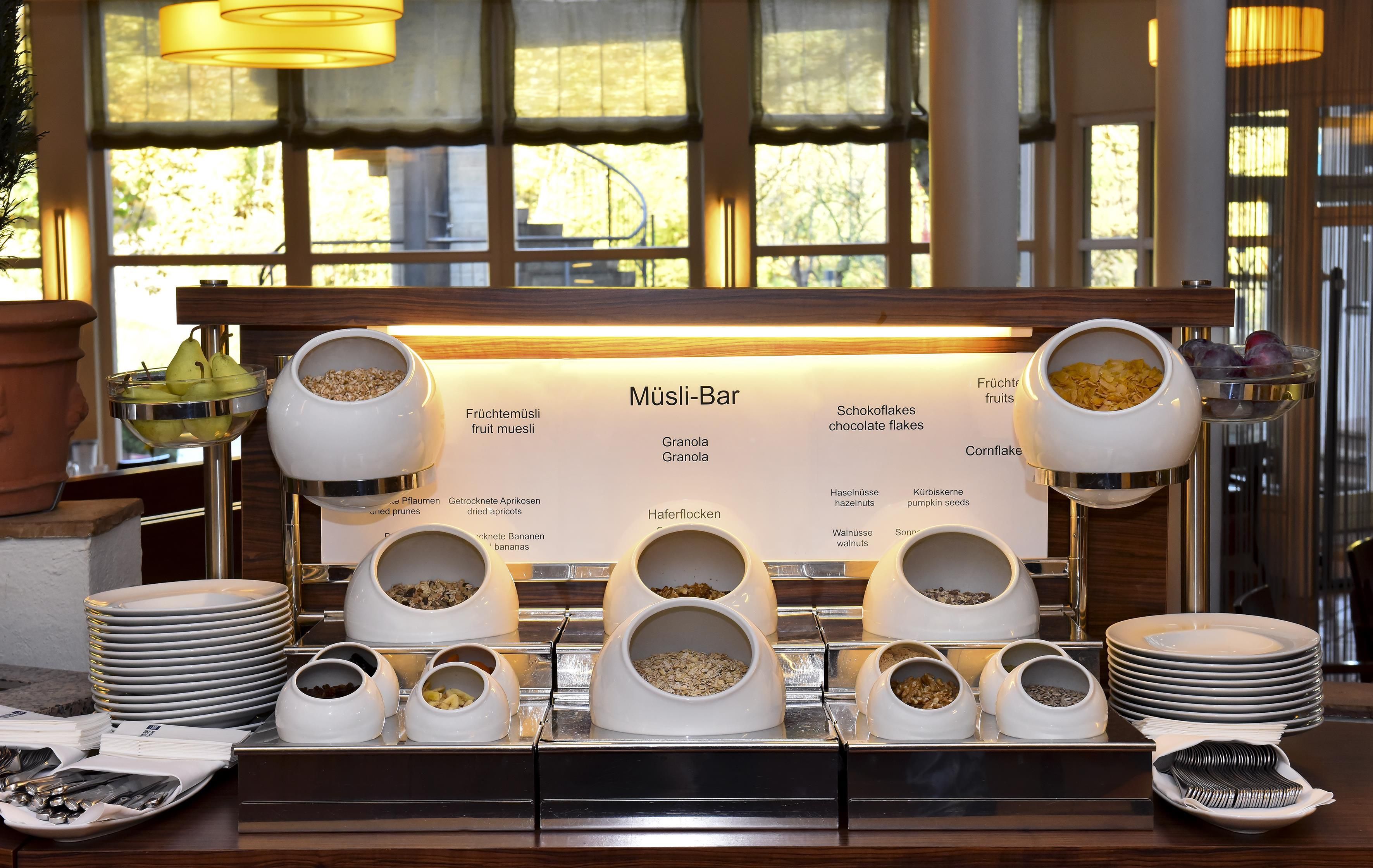 A breakfast buffet with various food items and utensils.