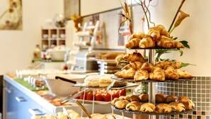 A buffet with various pastries and desserts displayed on tiered stands.