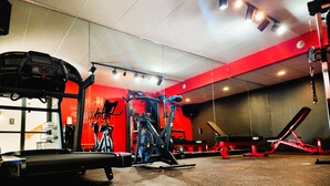A gym with various exercise equipment, including a treadmill, stationary bike, and weight machines. - The View Inn & Suites (Bethlehem)