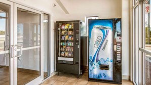A vending machine area with a selection of snacks and a water dispenser. - Motel 6 Euless, TX - DFW West (Euless)