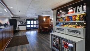 A restaurant interior with a counter, seating area, and snack display. - Hampton Inn Memphis-Poplar (Memphis)