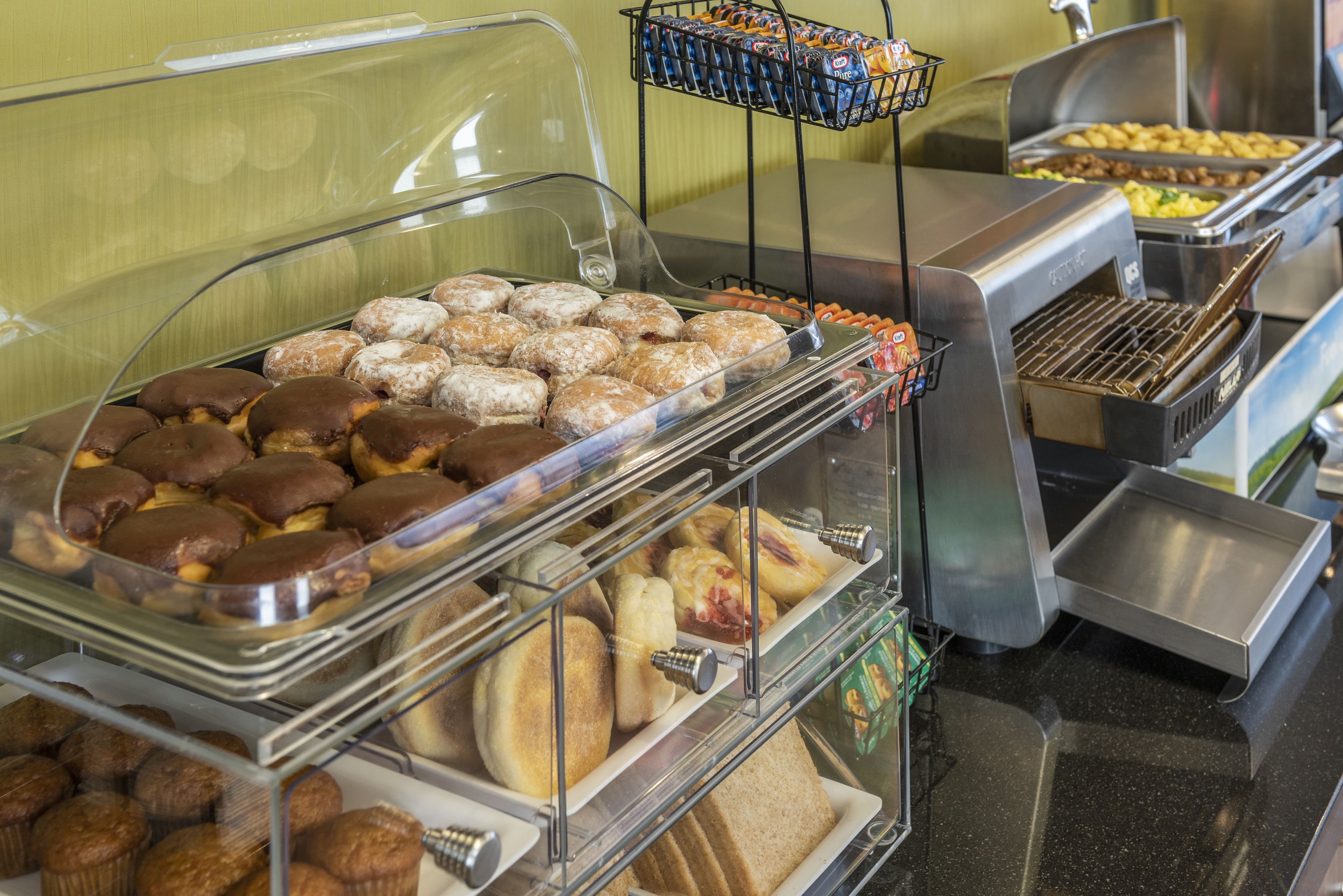 A buffet with various baked goods including pastries and muffins.