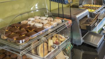 A buffet with various baked goods including pastries and muffins.